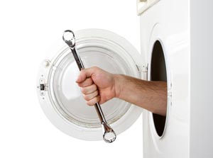 Repairman servicing washing machine